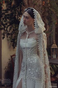 a woman in a white wedding dress with a veil on her head and long sleeves