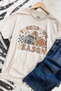 Get ready for touchdown season with our Checkered Football Season Graphic Tee! This retro-inspired tee features a bold football graphic and checkered design, perfect for showing off your love for the game! Add some sporty and nostalgic vibes to your wardrobe with this must-have tee. 52% cotton, 48% polyester round neckline unisex fit Southern Roots Boutique112 W Main St Paragould, AR *Please allow 5-7 business days processing time for this item to be shipped/picked up. Retro Tops For Football Season Streetwear, Retro Tops For Streetwear During Football Season, Football Season Graphic Tee Fan Gear, Football Season Fan Gear Graphic Tee, Sporty Fall T-shirt For Fan Merchandise, Graphic Print Tops For Fall Sports Events, Graphic Print Tops For Sports Events In Fall, Graphic Tee For Game Day And Fall, Sporty Fall Fan Merchandise T-shirt