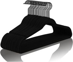 black clothes hangers on white background with reflection in the foreground, 3d image