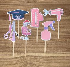 Hair Stylist Cupcake Toppers - Set of 12 Celebrate a hair stylist's graduation or milestone with these unique and adorable cupcake toppers! Features: - Set of 12 cupcake toppers attached to bamboo sticks - Printed on premium card stock for durability and quality - Designs include: hair dryer, scissors, curling iron, sit-down hair dryer hood, hair clip and spray bottle - Perfect for hair stylist graduation parties, beauty school celebrations, or hair salon events Details: - Each topper is approxi Cosmetology Graduation Party, Beauty School Graduation, Cosmetology Graduation, Hooded Hair Dryer, School Celebration, Graduation Party Supplies, Beauty School, Graduation Decorations, School Graduation