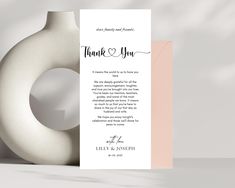 a white vase with a thank card next to it