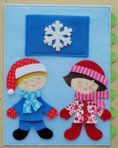 two felt dolls on a blue background with snowflakes and a small red hat