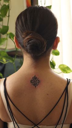 a woman with a tattoo on her back neck