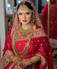 a woman wearing a red bridal outfit