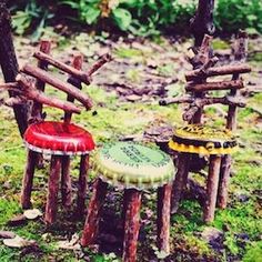 three wooden stools sitting in the grass