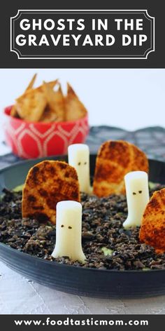 halloween treats with ghost faces in the graveyard dip on a black plate and white table cloth