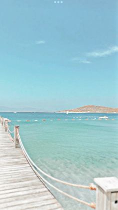 a wooden pier stretching out into the ocean