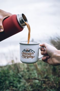 someone is pouring coffee into a white cup