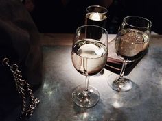 two wine glasses sitting on top of a table