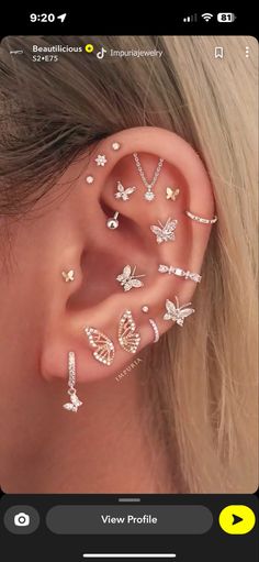 a woman with ear piercings that have butterflies on them