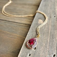 Beautiful Rose Petal Necklaces With Real Burgundy Rose Blossom In Resin. Petite Resin Pendant, That Magnifies The Rose Petals Through Each Rounded Side. Made With 18 Karat Gold Plated Stainless Steel Necklace Chain At 18 Inches Of Length. Perfectly Preserved Natural Jewelry With Colorful Dried Flower Petals. Boldly Colorful, Scarlet, Flower Jewelry Resin Jewelry Rose, Resin Rose Necklace, Red Resin Pendant Jewelry, Beach Charm Necklace, Red Resin Pendant Necklaces, Rose Petal Resin Pendant, Boho Bridal Jewelry, Agate Pendant Necklace, Silver Heart Pendant