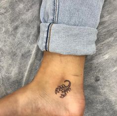 a small scorpion tattoo on the ankle