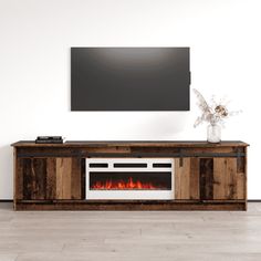 a television stand with a fireplace in the center