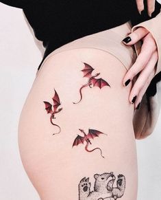 a woman's thigh with tattoos on her legs and an elephant in the middle