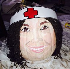 a woman's head with a red cross on it