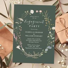 an engagement party card with flowers and greenery on the front, surrounded by presents