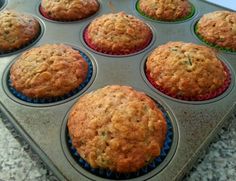 a muffin tin filled with lots of freshly baked muffins on top of a counter