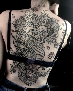 a woman with a dragon tattoo on her back