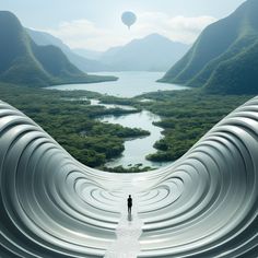 a person standing in the middle of a large structure with mountains and water behind them