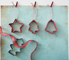 three cookie cutters are hanging on a string