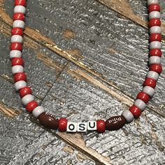 Necklaces are handmade and beaded to create a team themed color pattern complete with OSU and footballs. Measure about 17" long and worn over the head. Bead colors and material vary. Orders taken by request. Local pick up is available at the store, 115 E Lake St, Lakeview OH 43331, Tuesday - Saturday from 10am-6pm. Buckeye Jewelry, Buckeye Crafts, Football Necklace, Homemade Necklaces, State Crafts, Handmade Beaded Necklace, Diy Jewelry Necklace, Necklace Tutorial, Handmade Jewelry Necklace