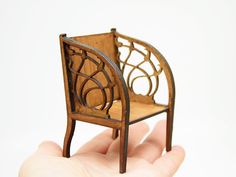 a miniature chair sitting on top of a hand