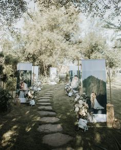 an outdoor ceremony setup with pictures and flowers