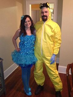 a man and woman dressed in costumes standing next to each other on a wooden floor