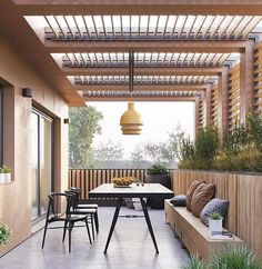 an outdoor dining area with seating and plants