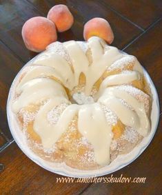 a bundt cake with icing and peaches on the side