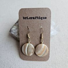 Lightweight and versatile, these earrings are going to be a staple in your wardrobe. Tote these these simple yet striking shell earrings with virtually any outfit.  Hung on a gold colored earwire. Width: 0.75 inches Equivalent to the size of a US nickel coin. Earring length: 1.75 inches Check out the Shell Earrings section for more styles and finishes. THINGS TO KNOW Due to the nature of shell, each bead will slightly vary in appearance from photo (thickness, iridescence, etc) No two are exactly alike! However, great detail is taken by maker to match each unique bead as closely as possible to the listing image above. SHIPPING:  All packages ship within 2-6 business days (Domestic/United States) unless otherwise indicated in listing. Customization and international subject to take longer (1 Adjustable Beige Earrings For Everyday, Adjustable Nickel-free Beige Earrings, Handmade Beige Round Earrings, Neutral Earrings, Beige Earrings, Earrings Classic, Classic Earrings, Disc Earrings, Seashell Crafts