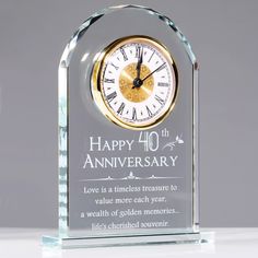 a glass clock that says happy 40th anniversary