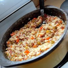 a pan filled with food sitting on top of a stove