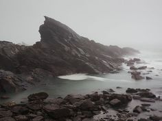 the rocks are covered in water and fog