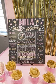 a chalkboard menu for a birthday party with chips and dips on the table