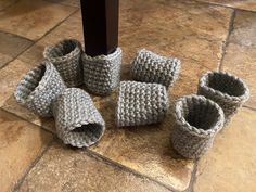 there are several crocheted baskets on the floor