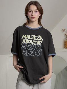 This is a comfortable and casual top by WAIKEI that is made out of high quality and sturdy material. With distinctive mood of the design and comfortable wear, you can style it for your feminine daily outfit.- Unique graphic artwork print- Color point on the neckline and sleeve- Trendy and casual mood Retro Black Slogan Tops, Retro Black Tops With Text Print, Retro Black T-shirt With Slogan, Vintage Black Slogan Tops, Retro Black Top With Front Print, Black Retro Tops With Relaxed Fit, Black Retro Top With Relaxed Fit, Black Retro Tops In Relaxed Fit, Retro Black Tops With Graphic Design