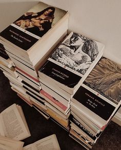 a stack of books sitting on top of a carpeted floor