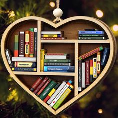 a heart shaped book shelf filled with books