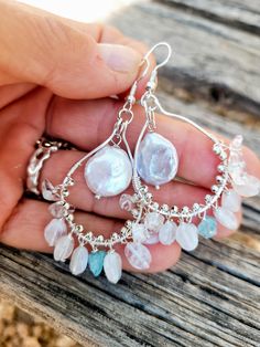 The earrings are made of beautiful natural moonstones dangle  on silver hooks and natural  pearl in the middle of the hook. The blue crystal of apatite between dangling moonstones add the sofisticated look. Complex in color - moonstones and pearls have iridescent colors. Perfect pear of earrings for your wedding gown.  The size of the pearl is 12 mm in diameter.  Length ( with ear hooks) is a little over 2 1/2 inches. The ear wires are silver plated. Please visit my Policies page for shipping and additional information: http://www.etsy.com/shop/BridalBay/policy Arrives in a gift box for easy gift-giving. Handmade Briolette Pearl Earrings, Sterling Silver Dangle Crystal Earrings With Pearl Drop, Silver Dangle Teardrop Earrings With Natural Stones, Silver Teardrop Chandelier Earrings With Natural Stones, Pearl Dangle Earrings With Natural Stones, Teardrop Pearl Earrings With Natural Stones, Sterling Silver Pearl Drop Earrings With Dangling Beads, Sterling Silver Drop Earrings With Dangling Pearls, Handmade Silver Pearl Chandelier Earrings