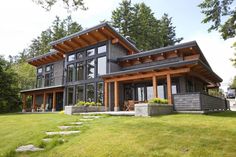 a large house with lots of windows in the front yard