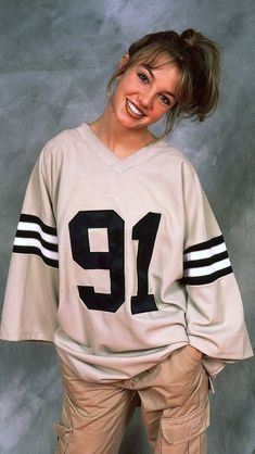 a woman wearing a jersey with the number 19 on it is posing for a photo