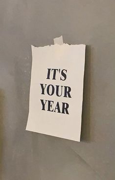 a piece of paper with the words it's your year written on it next to a toilet