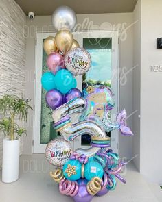 a bunch of balloons that are in front of a door