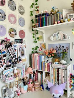 a room filled with lots of different items and pictures on the wall next to bookshelves