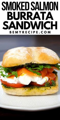 a sandwich with tomato, mozzarella and basil on it sitting on a white plate