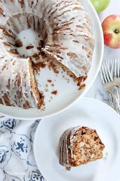 a bundt cake sitting on top of a white plate next to an apple slice