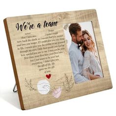 a wooden frame with an image of a couple holding each other and the words we're