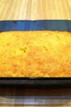 a pan filled with food sitting on top of a wooden table