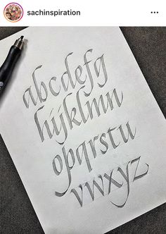 an image of some type of writing on paper with a pen next to it and another type of lettering that is in the upper right corner